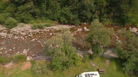 van life park near river valley on tropical forest at summer in northern italy