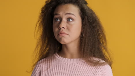 nervous caucasian curly haired woman in front of the camera.