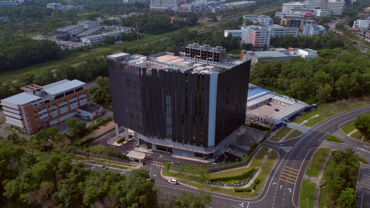 Big new data center building in malaysia, featuring contemporary architecture and hosting critical digital infrastructure services. Lovely aerial view fly push forward drone