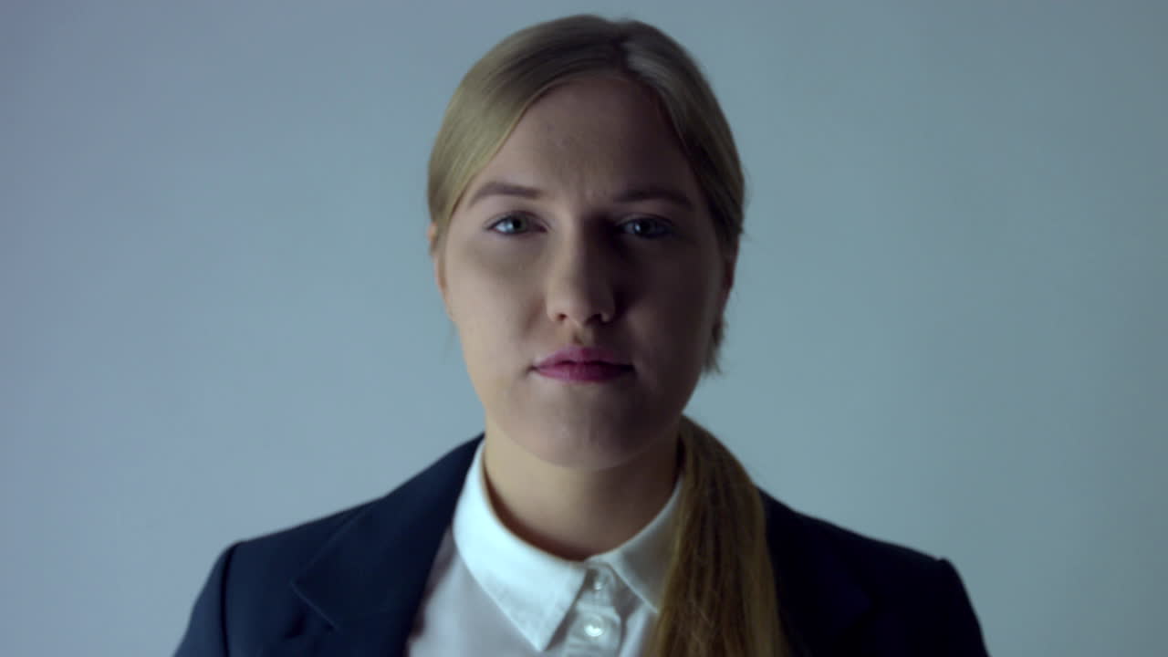 The camera moves away from a serious business woman