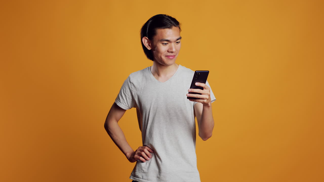 Modern young adult browsing internet on smartphone