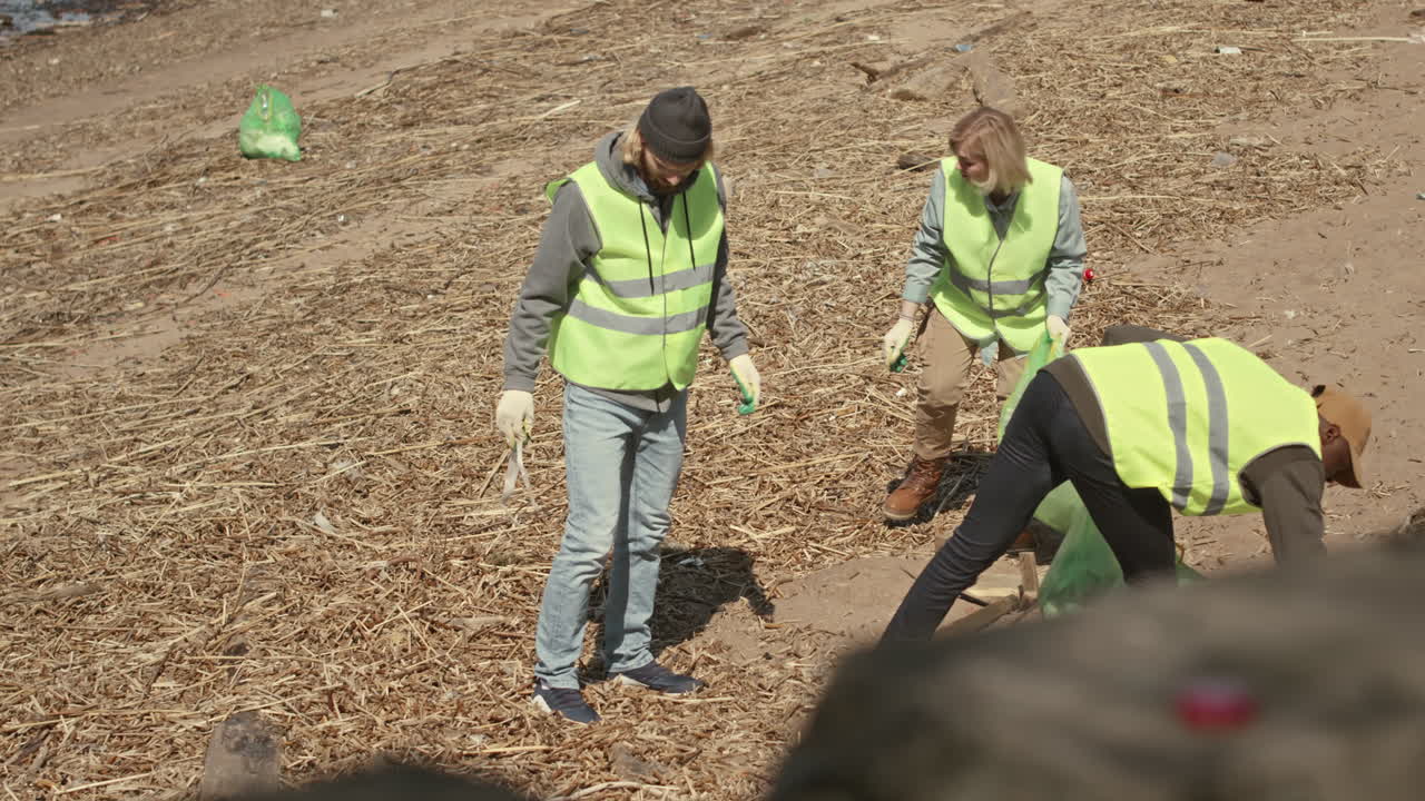 Group of Environmental Volunteers Doing Shoreline Cleanup