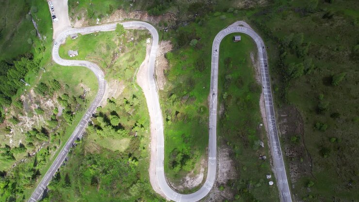 Top down aerial shot of curvy twisted mountain road in Passo Giau, Italy