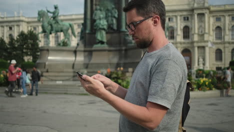 man using smartphone in a european city
