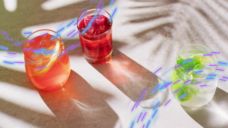 animation of light trails and cocktails on white background