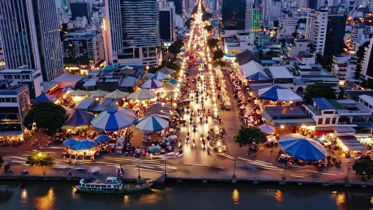 Aerial view of a bustling city street market at dusk, with vibrant lights and busy traffic, perfect