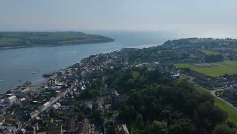 youghal, county cork, ireland, september 2024. drone panoramic aerial clockwise orbit establishing the harbour along river blackwater with stunning views of traditional architecture and homes.