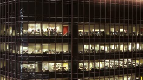 office building at night with people working