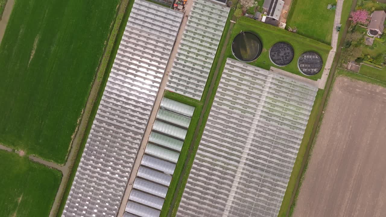 Aerial view of glass farming structures in open Dutch landscape