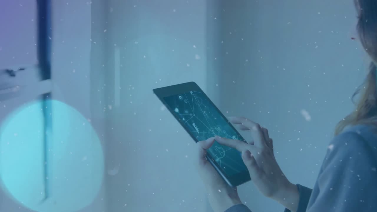 Woman raising tablet beside window scrolling business data charts for analysis with drifting bokeh