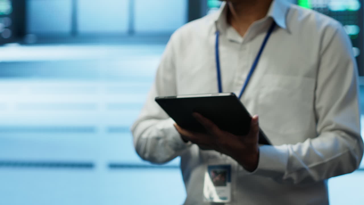 IT professionals updating server room systems using tablet