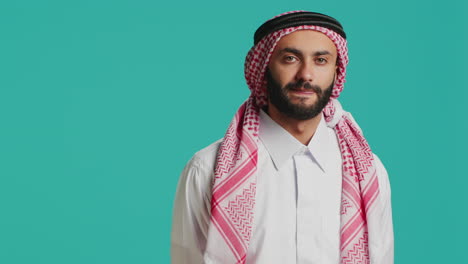 person wearing national thobe and kufiyah