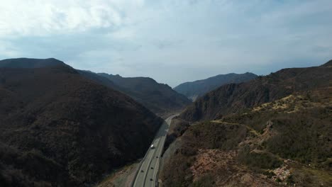 Long-road-leading-towards-mountains-in-Albania-through-steep-slopes-of-river-valley