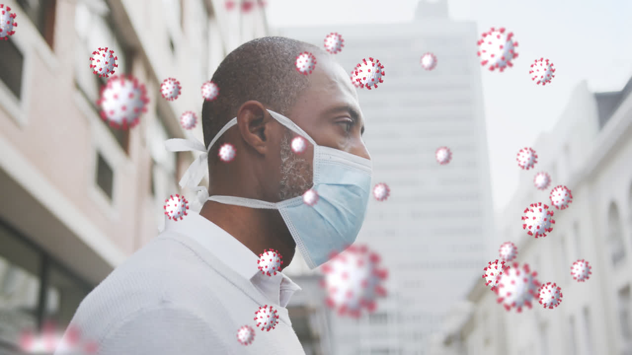 Animation of covid 19 cells over african american man wearing face mask