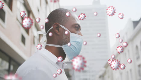 animation of covid 19 cells over african american man wearing face mask