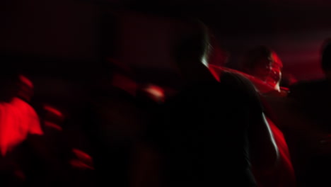 blurred crowd of people dancing at a vibrant party with colorful lights and energetic atmosphere