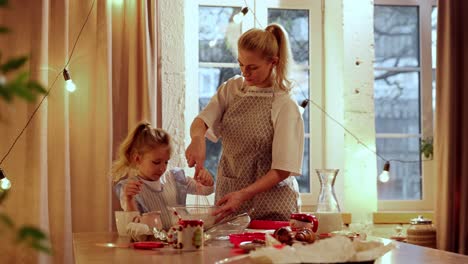 mother and daughter baking christmas cookies