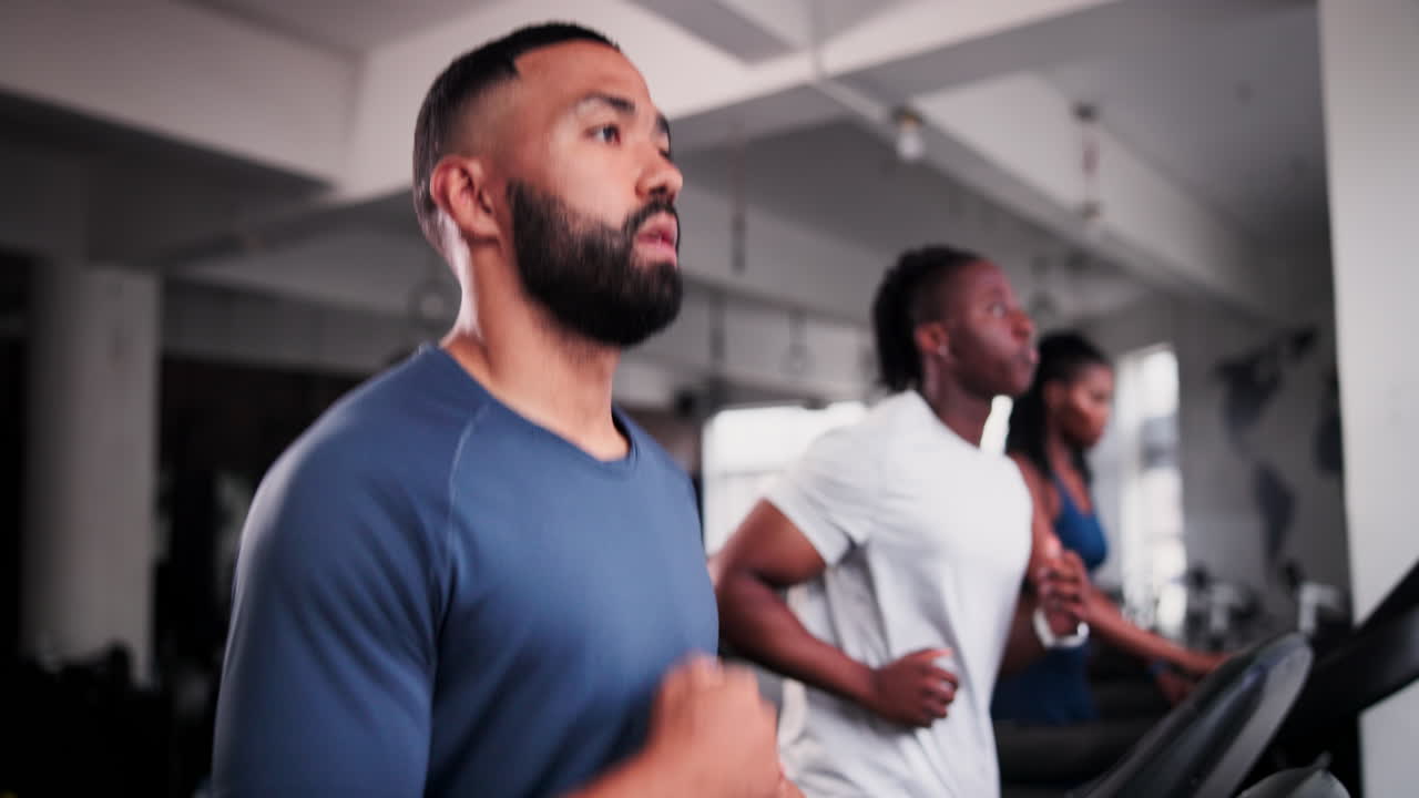 Men Exercising on Treadmills in a Gym