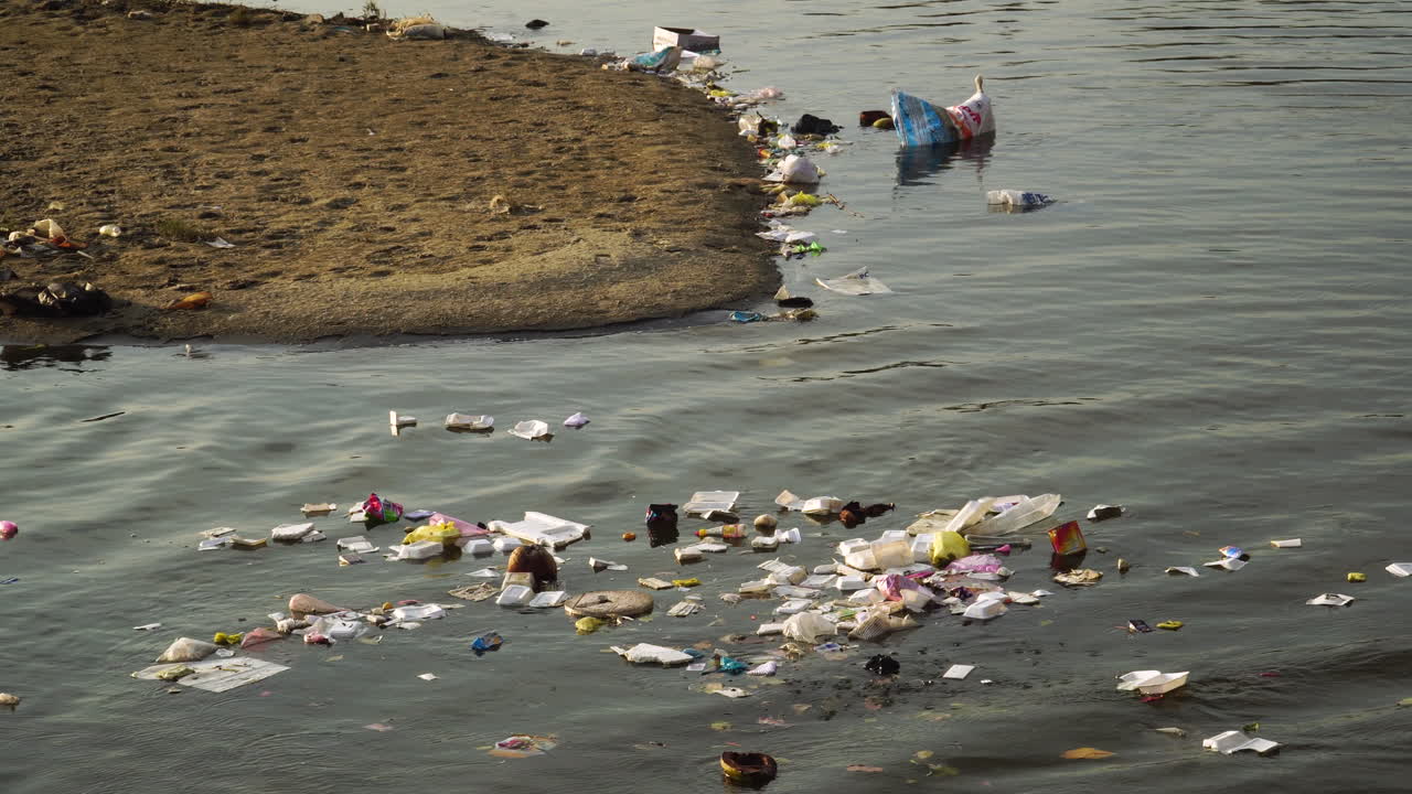 Human garbage polluting the environment, discarded trash floating in water