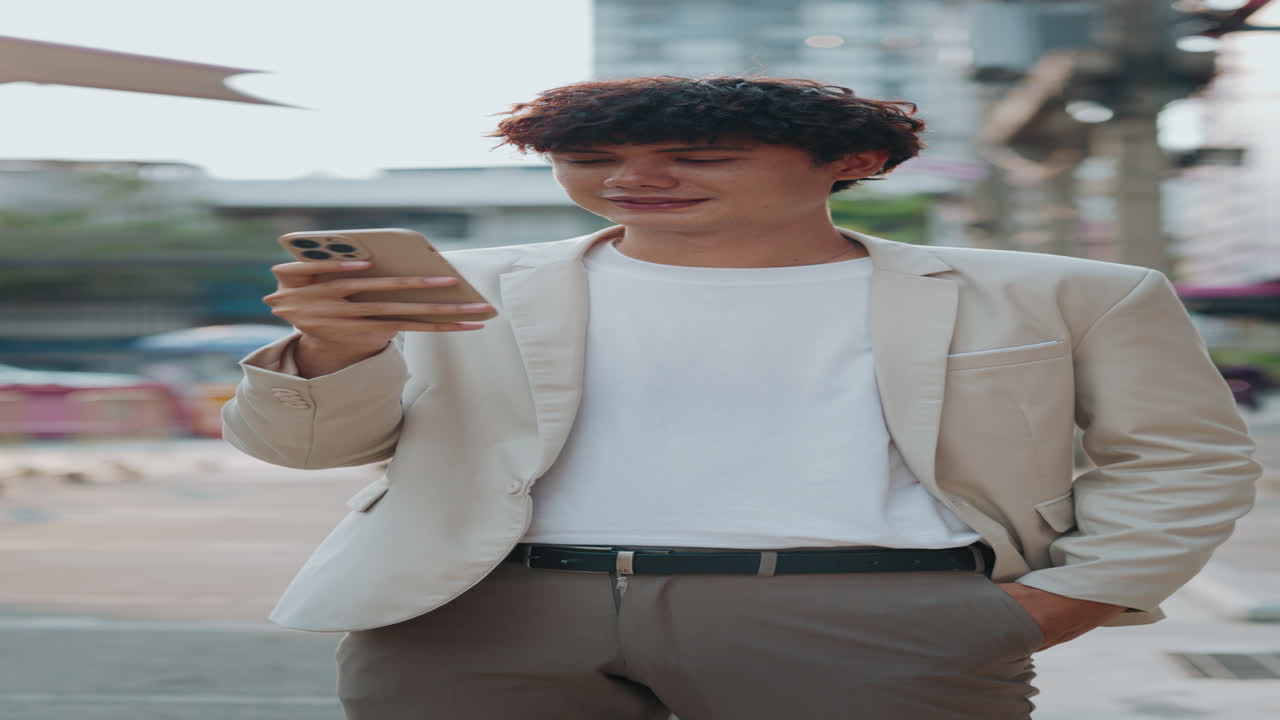 Young man using smartphone on city street