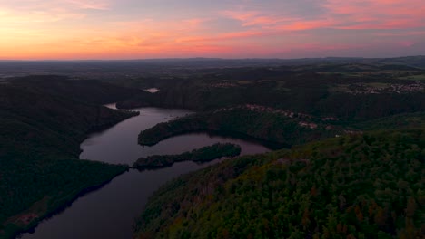 aerial wide shot revealing loire river in the gorges de la loire at sunset, loire departement, auvergne rhone alpes region, france