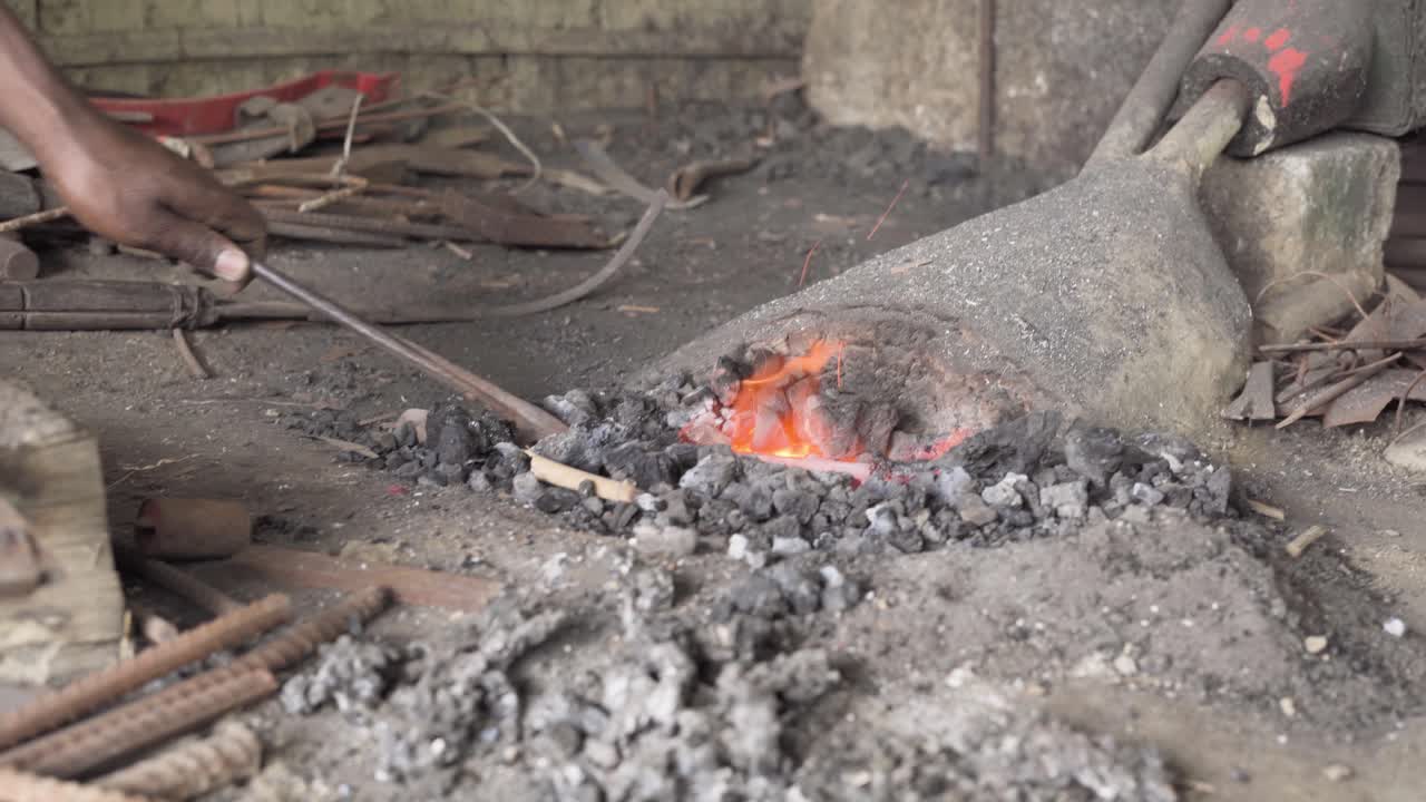Pumping hand crank manual forge blower in a grungy workshop