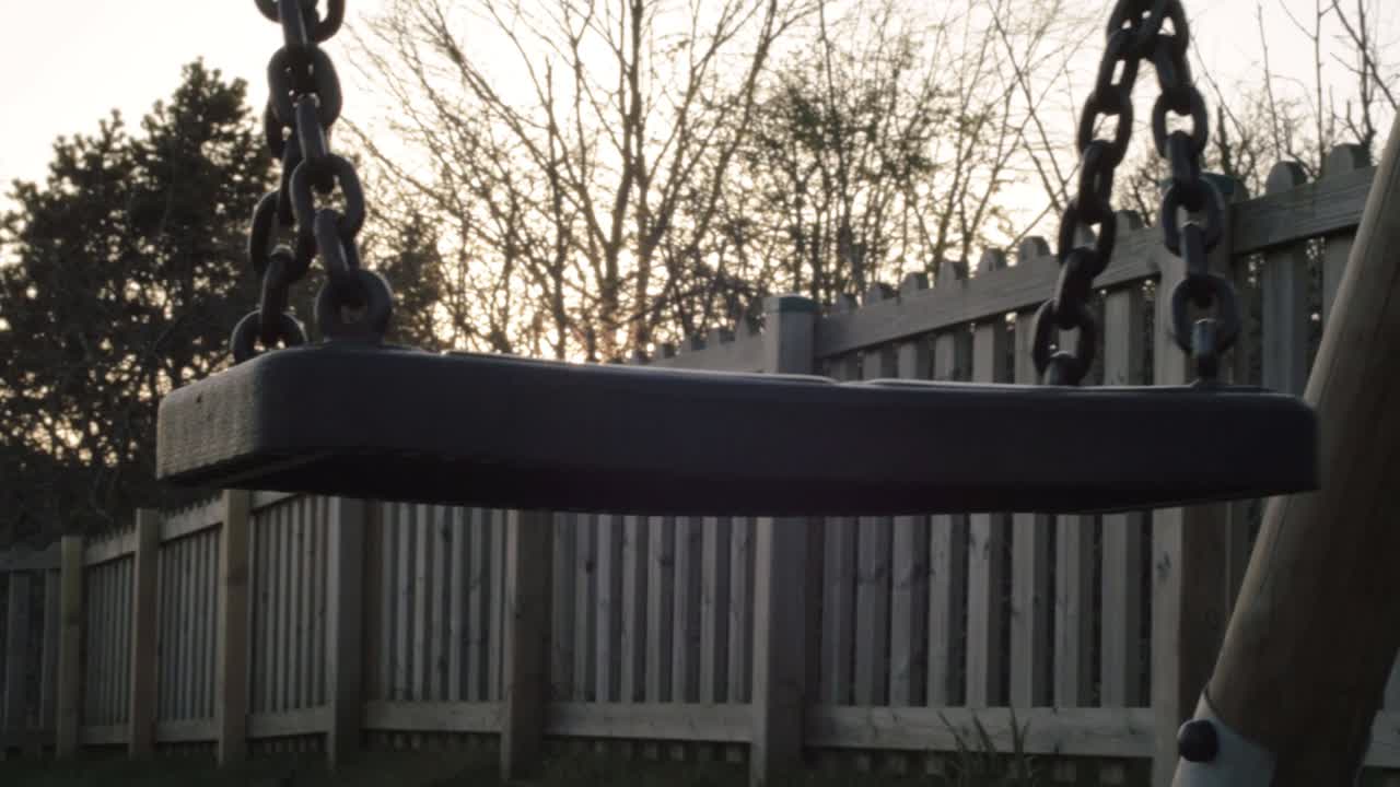 Swing Set in Backyard at Sunset