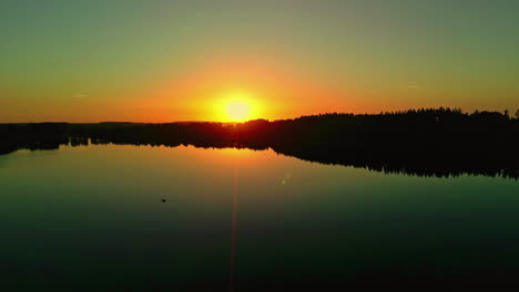 A-Reveal-Shot-Of-A-Clear-Sky-During-The-Golden-Hour-On-A-Forest-Landscape-By-The-Lake