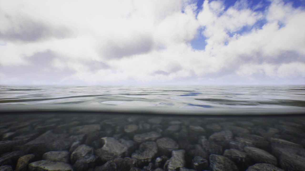 View of tranquil water surface with clouds reflecting above and stones below
