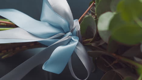 silk blue ribbon and bow tied on fresh flower bouquet