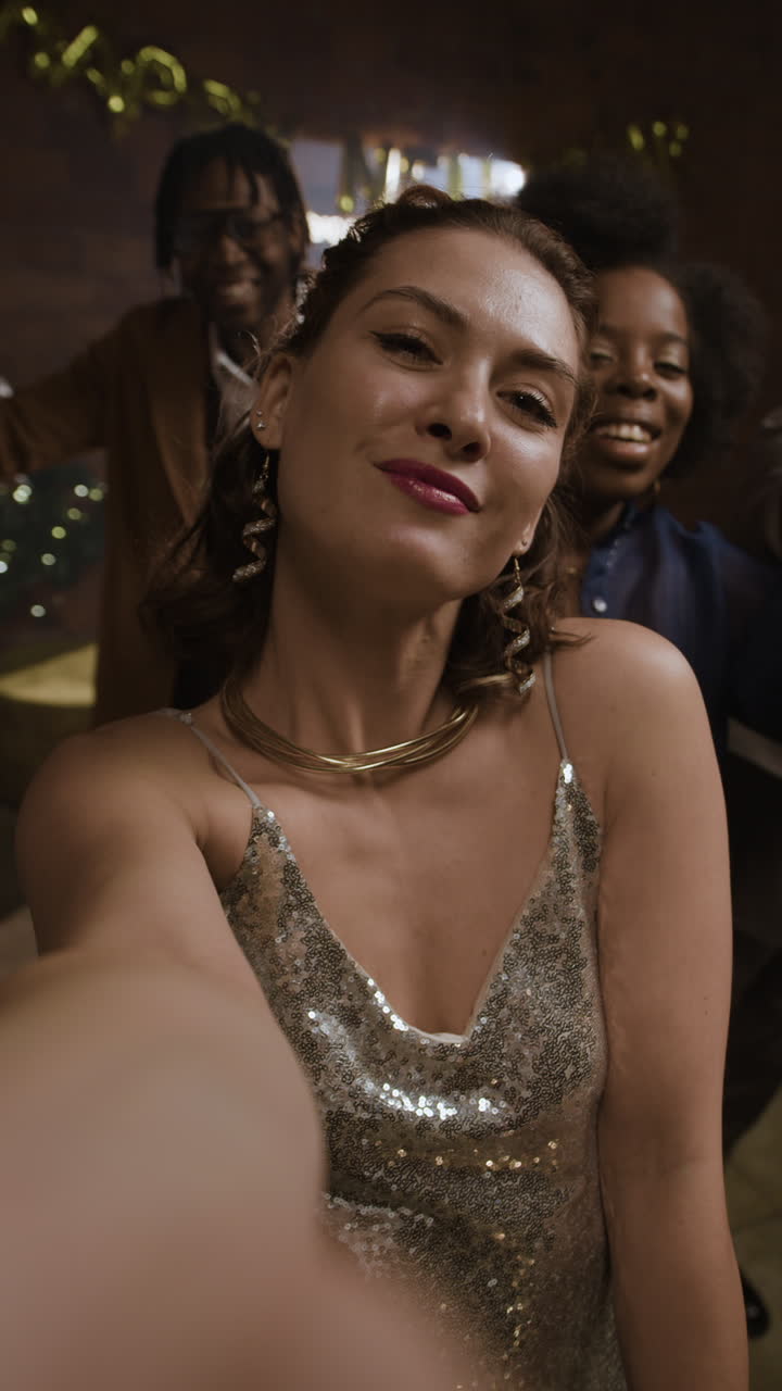 A woman takes a selfie at a party