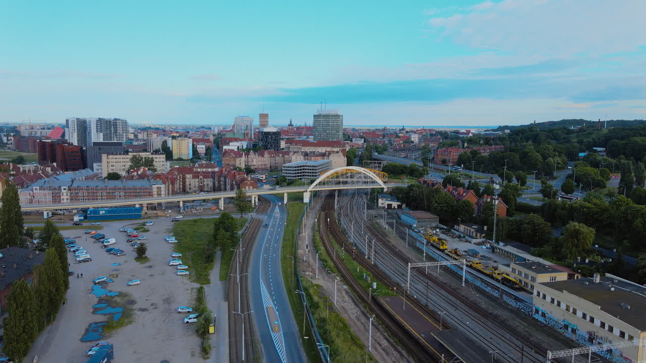 Aerial horizontal view panorama of Gdansk, little traffic on the city streets at sunset, in the background, bridges and railway tracks, high buildings in the distance