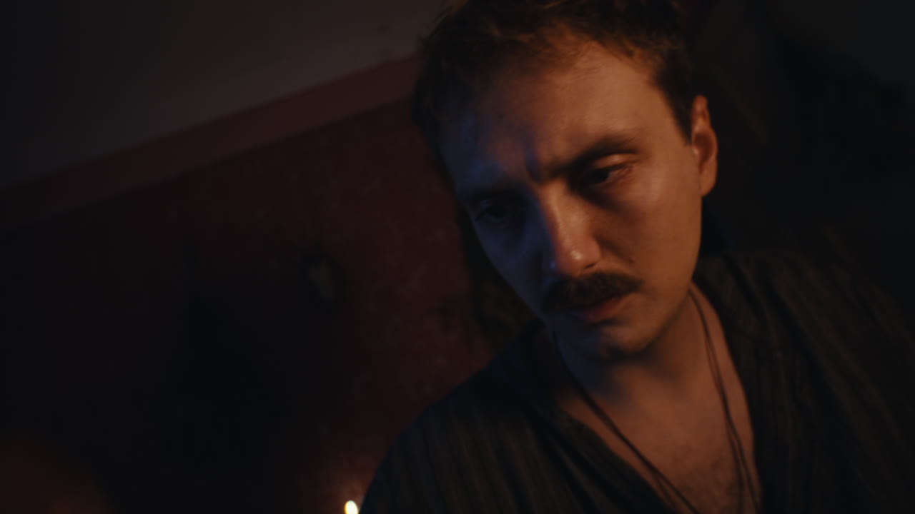 Man with Mustache in Low Light