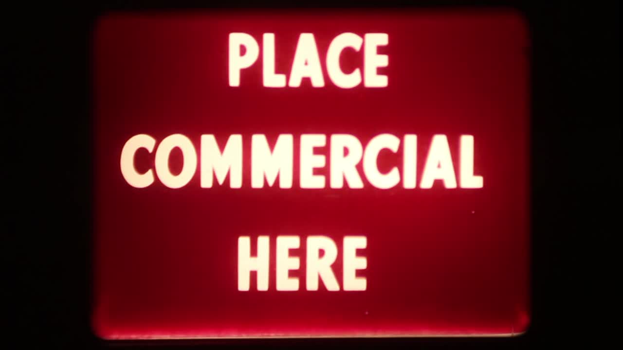 Retro 'Place Commercial Here' Text on Old Film Screen