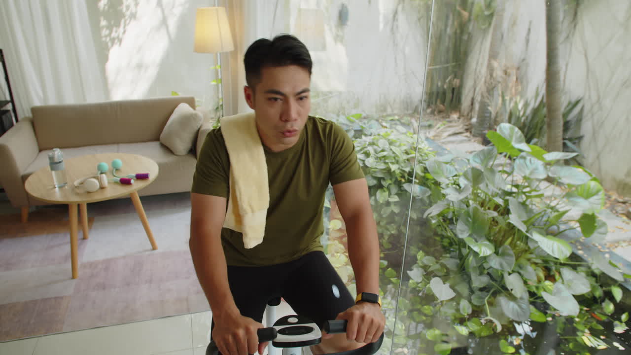 Male Athlete Practicing Exercise on Fitness Bike