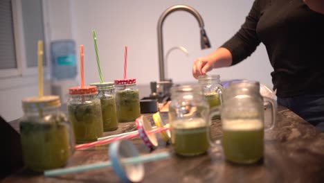 young latin girl prepare cocktail mocktail or smoothie at her kitchen