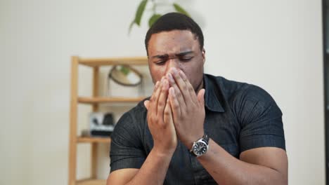 a dark-skinned man applies disinfectant and rubs his hands