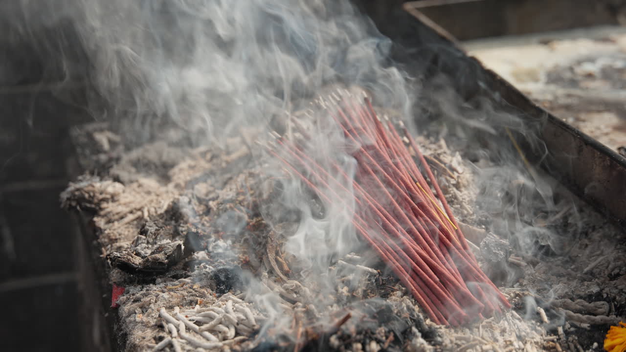 Incense burns inside a Nepali temple, releasing waves of fragrant smoke that fill the air with serenity and spirituality — a cinematic vision of faith and divine calm