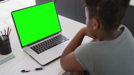 Animation-of-african-american-girl-having-online-lessons-on-laptop-with-copy-space-home
