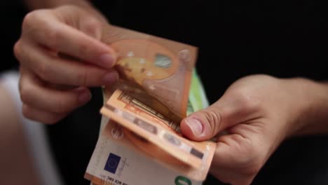 male hands counting euro bills of 100 and 50