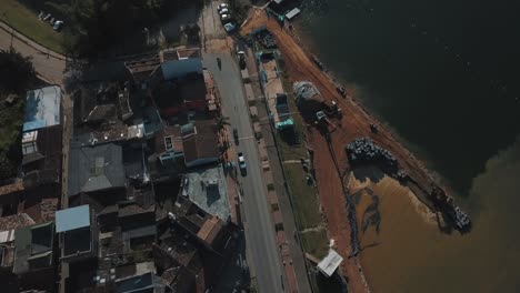 Drone-aerial-Bird's-eye-view-of-the-city-revealing-the-lake-in-El-peñol-Guatapé,-Medeliin,-Colombia