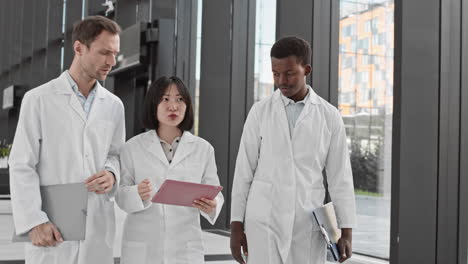 group of three diverse scientists using digital tablet