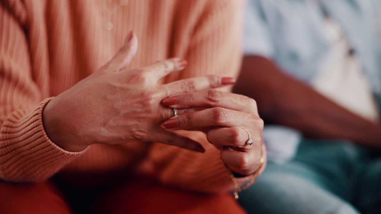 Woman Adjusting Her Wedding Ring While Sitting