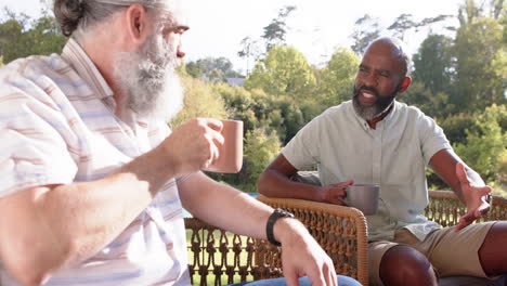 senior friends enjoying coffee and conversation on outdoor patio chairs