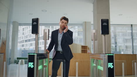 hurrying man using smartwatch for open office turnstile running on workplace.