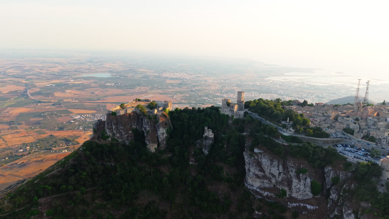 Erice Village And Castle Overlooking The Tyrrhenian Coastline At Sunset In Sicily, Italy. - aerial shot