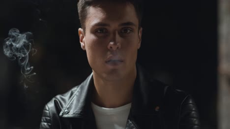 young man smoking in the night