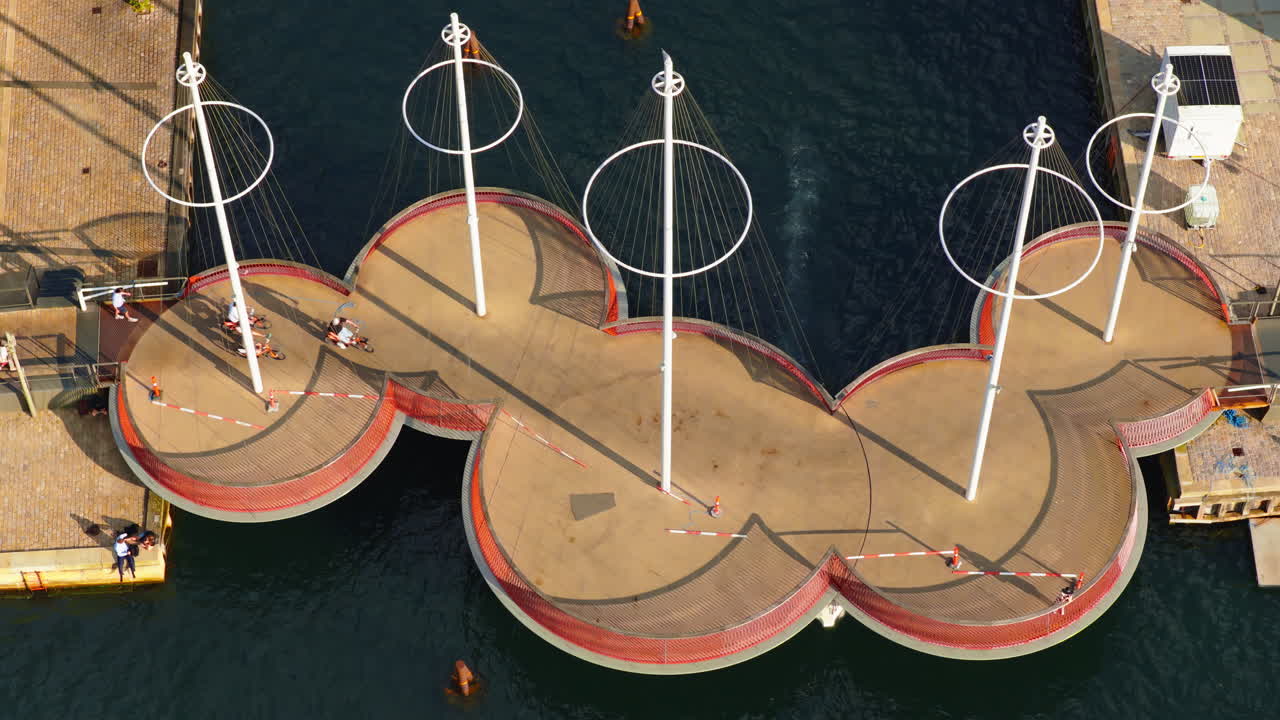 Copenhagen, Denmark - August 7, 2025: Aerial drone view of the Circle Bridge with people crossing and boats below