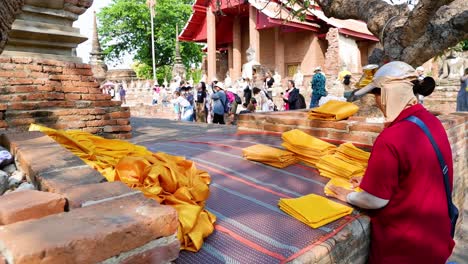 monk arranging robes at ayutthaya temple