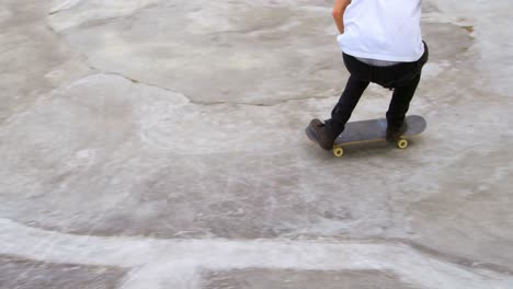 side view of young caucasian man practicing skateboarding on ramp in skateboard park 4k